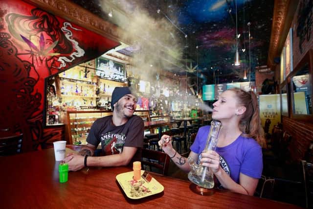 Customers smoke marijuana at the New Amsterdam Cafe in Vancouver, British Columbia, Canada, where Marijuana has been legal since 2018.