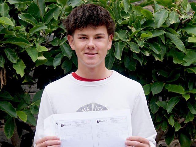 St Leonards pupil with his GCSE results envelope. Photo: St Leonards School