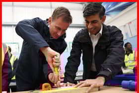 Prime Minister Rishi Sunak (right) and Chancellor of the Exchequer Jeremy Hunt doing electrical work during a visit to the Enfield Centre, part of the Capital City College Group,  in north London. Picture: Daniel Leal/PA Wire
