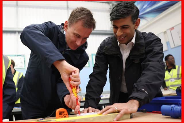 Prime Minister Rishi Sunak (right) and Chancellor of the Exchequer Jeremy Hunt doing electrical work during a visit to the Enfield Centre, part of the Capital City College Group, in north London. Picture: Daniel Leal/PA Wire