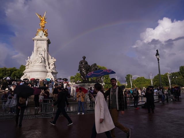 The crowd outside Buckingham Palace has grown to about 1,000 people.
A helicopter is circling overhead as people wait quietly for any news on the well-being of the Queen.
