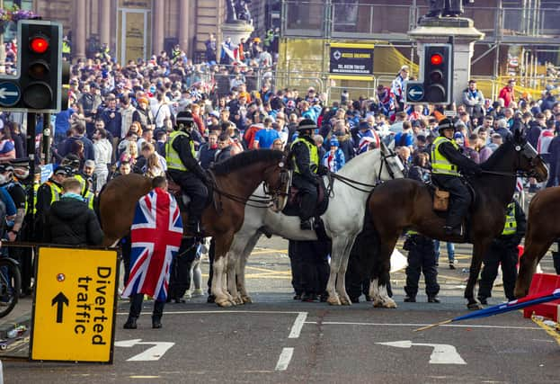 Five police officers were injured and 28 people were arrested during disorder in Glasgow's George Square as Rangers fans celebrated winning the Scottish Premiership title (Picture: Lisa Ferguson)






Rangers fans gather at George Square this afternoon after Rangers lift The SPFL Premier League Cup on the last day of the season