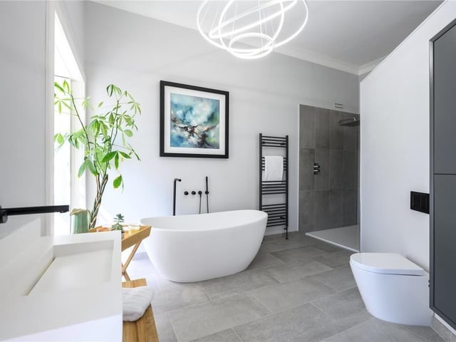 Principal en-suite with free standing bath and separate shower.