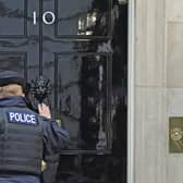 A police officer knocks on the door of the Prime Minister's official residence in Downing Street. Picture: PA