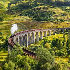 The Jacobite steam train passing over the Glenfinnan Viaduct
