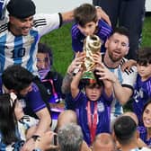 Argentina's Lionel Messi sits with family members after the FIFA World Cup final at Lusail Stadium, Qatar.