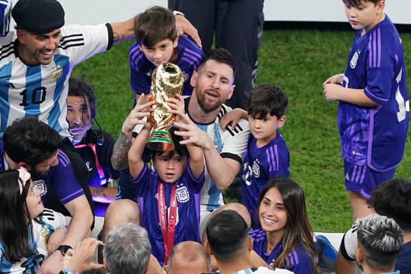 Argentina's Lionel Messi sits with family members after the FIFA World Cup final at Lusail Stadium, Qatar.