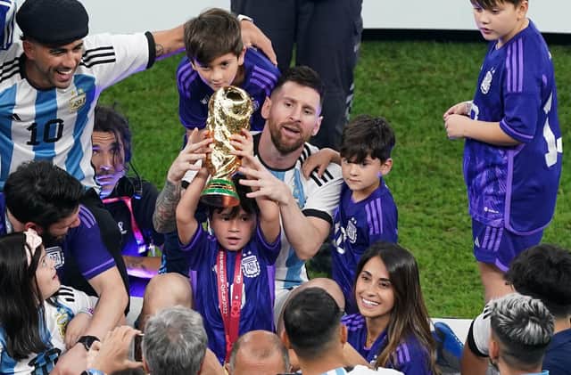 Argentina's Lionel Messi sits with family members after the FIFA World Cup final at Lusail Stadium, Qatar.