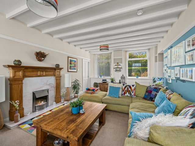 Exterior: The garden includes a lawn, timber decking, summerhouse and large garage/workshop.