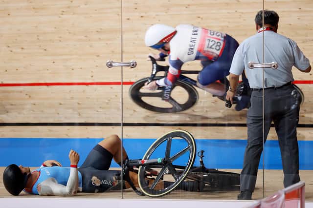 Britain's Jack Carlin cycles on the banking as Hugo Barrette of Canada crashes during the men's keirin first round at Izu Velodrome. Picture: Justin Setterfield/Getty Images