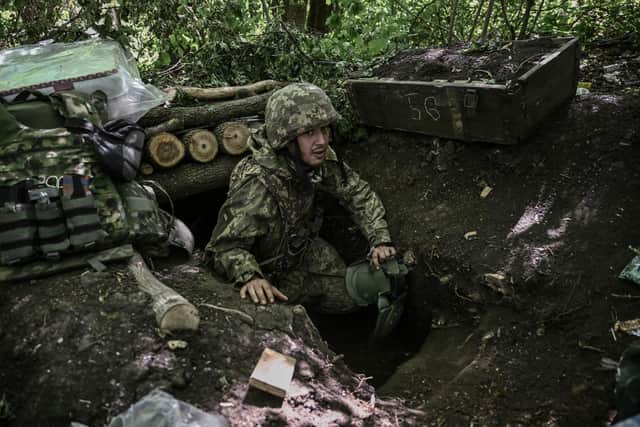 A Ukrainian serviceman gets out of an underground makeshift bunker after a shelling at a field camp near the front line at an undisclosed location in the eastern Ukrainian region of Donbas on June 6, 2022. (Photo by ARIS MESSINIS / AFP) (Photo by ARIS MESSINIS/AFP via Getty Images)