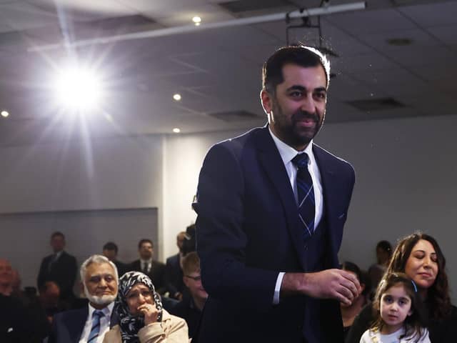 Humza Yousaf walks to the stage to speak after being elected as new SNP party leader