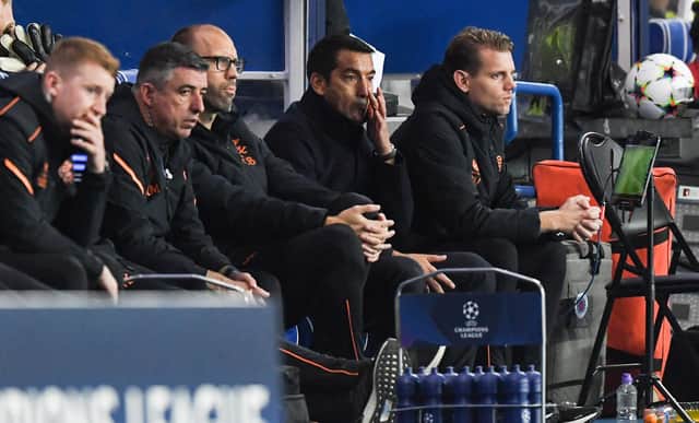 Giovanni van Bronckhorst cuts a dejected figure in the Rangers dugout.