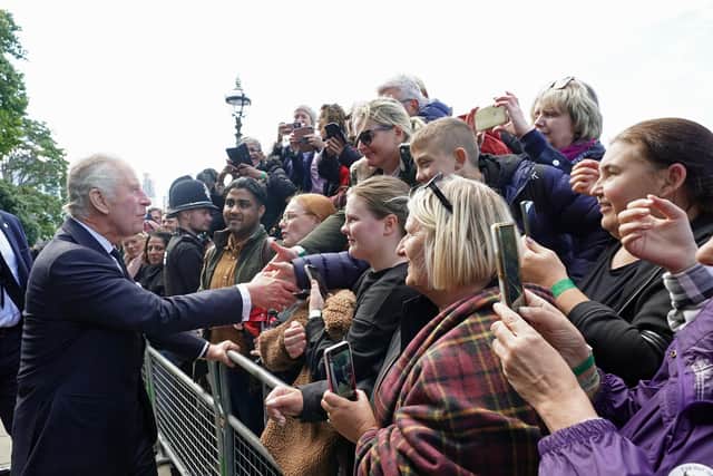King Charles III meets members of the public in the queue along the South Bank, near to Lambeth Bridge, London, as they wait to view Queen Elizabeth II lying in state ahead of her funeral on Monday. Picture: PA