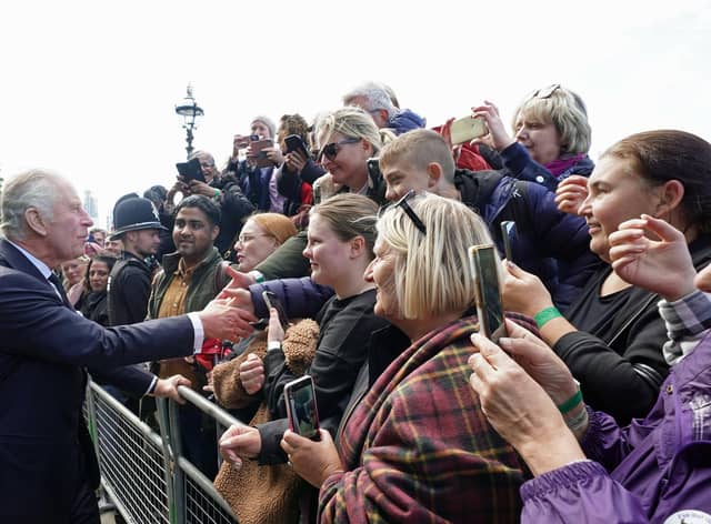 King Charles III meets members of the public in the queue along the South Bank, near to Lambeth Bridge, London, as they wait to view Queen Elizabeth II lying in state ahead of her funeral on Monday. Picture: PA