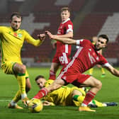 Hibs striker Christian Doidge tussles with Aberdeen midfielder Connor McLennan at Pittodrie.