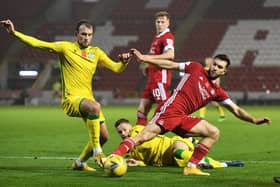 Hibs striker Christian Doidge tussles with Aberdeen midfielder Connor McLennan at Pittodrie.
