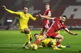 Hibs striker Christian Doidge tussles with Aberdeen midfielder Connor McLennan at Pittodrie.