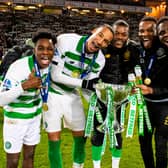 Olivier Ntcham, centre, and Christopher Jullien, left-centre, celebrate after beating Rangers in the 2019 League Cup final.
