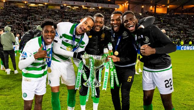 Olivier Ntcham, centre, and Christopher Jullien, left-centre, celebrate after beating Rangers in the 2019 League Cup final.