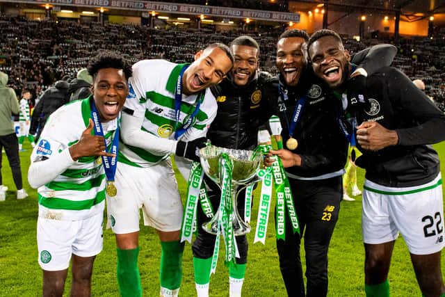 Olivier Ntcham, centre, and Christopher Jullien, left-centre, celebrate after beating Rangers in the 2019 League Cup final.
