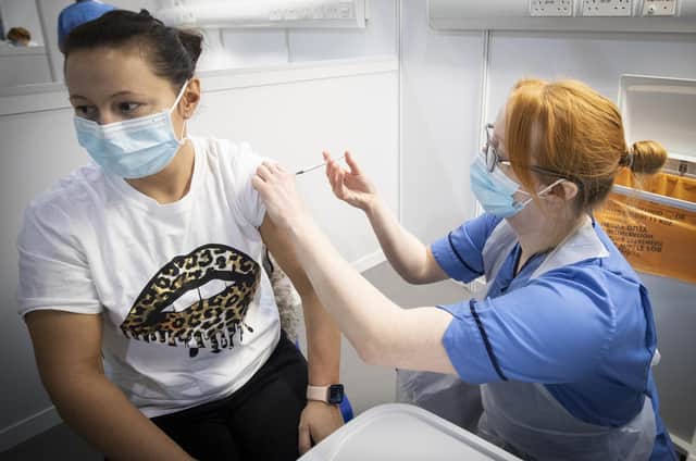 Nurse Eleanor Pinkerton administers a coronavirus vaccine to one of the health and social care staff at the NHS Louisa Jordan Hospital in Glasgow.