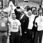 Fans wearing their Hands off Hibs! t-shirts celebrate the news that Hearts FC chairman Wallace Mercer has withdrawn his offer to buy Hibernian FC football team, July 1990,