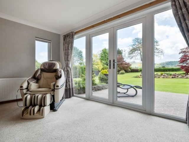 Principal bedroom with doors to rear garden.
