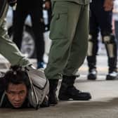 Riot police detain a man as they clear protesters taking part in a rally against a new national security law in Hong Kong on July 1 (Picture: dale de la Rey/AFP via Getty Images)