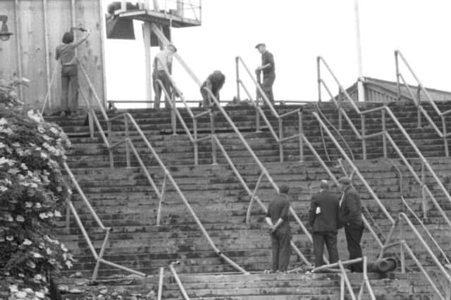 Workmen clear the barricades from stairway 13 at Ibrox stadium, scene of the tragedy that killed 66 football fans on January 2 1971. PIC: TSPL.