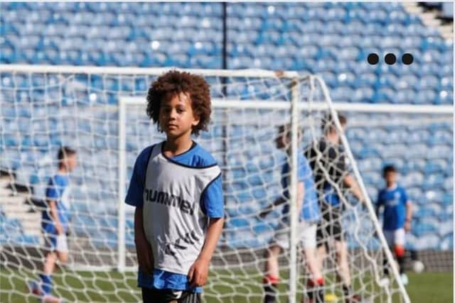 Isaiah Muzaale, 9, playing football
