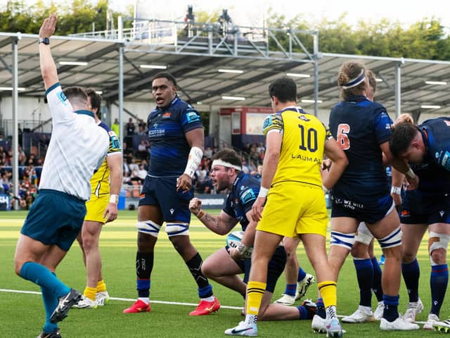 Ewan Ashman, centre with headband, clenches his fist to celebrate the second of his two tries in Edinburgh's 40-14 win over Zebre Parma at Hive Stadium. (Photo by Paul Devlin / SNS Group)