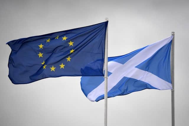 The EU flag and Saltire flutter side by side. All of the "New Scots" interviewed by Barbara Henderson originally came from the EU PIC: Getty Images