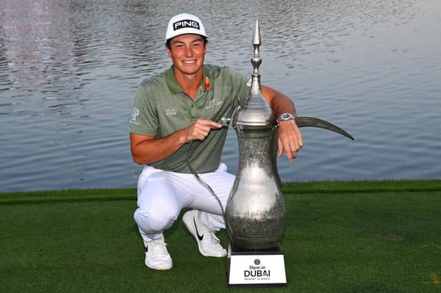 Viktor Hovland poses with the Dallah Trophy after his victory in the Slync.io Dubai Desert Classic at Emirates Golf Club. Picture: Ross Kinnaird/Getty Images.
