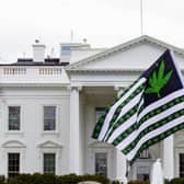A demonstrator waves a flag with marijuana leaves depicted on it during a protest calling for the legalization of marijuana, outside of the White House on April 2, 2016, in Washington. President Joe Biden is pardoning thousands of Americans convicted of simple possession of marijuana under federal law, as his administration takes a dramatic step toward decriminalizing the drug. (AP Photo/Jose Luis Magana, File)