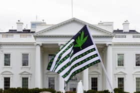 A demonstrator waves a flag with marijuana leaves depicted on it during a protest calling for the legalization of marijuana, outside of the White House on April 2, 2016, in Washington. President Joe Biden is pardoning thousands of Americans convicted of simple possession of marijuana under federal law, as his administration takes a dramatic step toward decriminalizing the drug. (AP Photo/Jose Luis Magana, File)