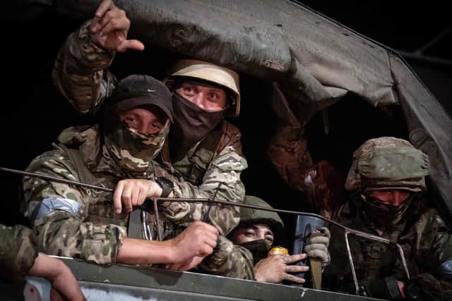 Members of Wagner group looks from a military vehicle in Rostov-on-Don late on June 24, 2023. Rebel mercenary leader Yevgeny Prigozhin who sent his fighters to topple the military leaders in Moscow will leave for Belarus and a criminal case against him will be dropped as part of a deal to avoid "bloodshed," the Kremlin said on June 24.
