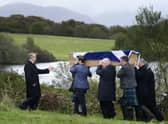 Mourners carrying the coffin of Ian Hamilton KC to his burial in a plot in the grounds of his old house at Loch Na Beithe, North Connel