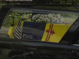 The logo is visible as the hearse leaves Balmoral. Picture: BBC