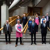 Delegates and MSPs at this week's Scotch lamb campaign presentation at Holyrood. (Jim Fairlie front row second left in pink apron)
