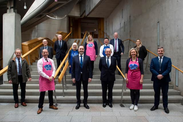 Delegates and MSPs at this week's Scotch lamb campaign presentation at Holyrood. (Jim Fairlie front row second left in pink apron)