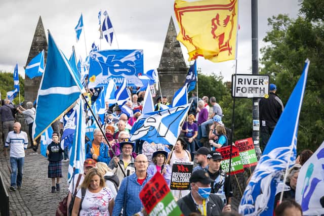 Supporters of Scottish independence march over the Auld Brig on their way to the site of the Battle of Bannockburn (Picture: Jane Barlow/PA)