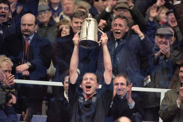A 'drookit' Andy Nicol lifts the Calcutta Cup after the 19-13 win over England at Murrayfield on April 2, 2000. Pic: Dave Rogers /Allsport