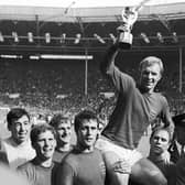 England's soccer team captain Bobby Moore, is carried shoulder high by his teammates holding World Cup at the Wembley Stadium in London, July 30, 1966.