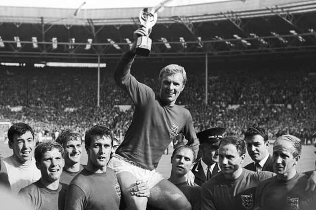 England's soccer team captain Bobby Moore, is carried shoulder high by his teammates holding World Cup at the Wembley Stadium in London, July 30, 1966.