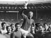 England's soccer team captain Bobby Moore, is carried shoulder high by his teammates holding World Cup at the Wembley Stadium in London, July 30, 1966.