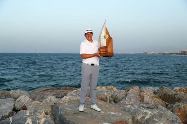 Sami Valimaki of Finland poses with the trophy after winning the 2020 Oman Open at Al Mouj Golf in Muscat. Picture: Warren Little/Getty Images.