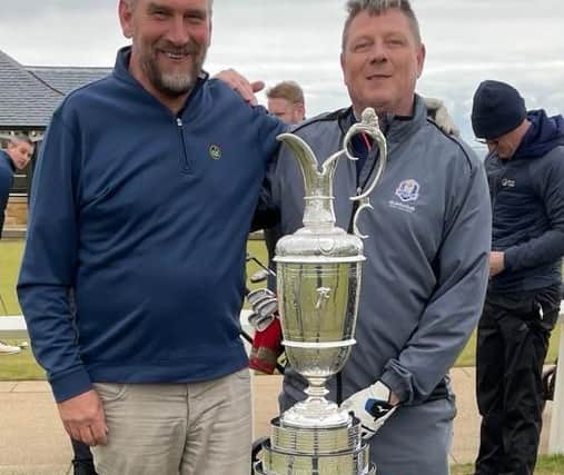 Martin Dempster, The Scotsman golf correspondent, and the Daily Record's Craig Swan with the Claret Jug before teeing off on the Old Course at St Andrews.