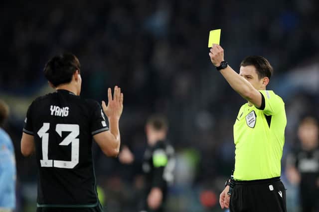 Halil Umut Meler shows a yellow card to Yang Hyun-Jun of Celtic during the Champions League match against Lazio at Stadio Olimpico on November 28. (Photo by Paolo Bruno/Getty Images)