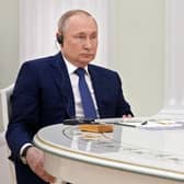 Russian President Vladimir Putin listens to French President Emmanuel Macron during their meeting in the Kremlin